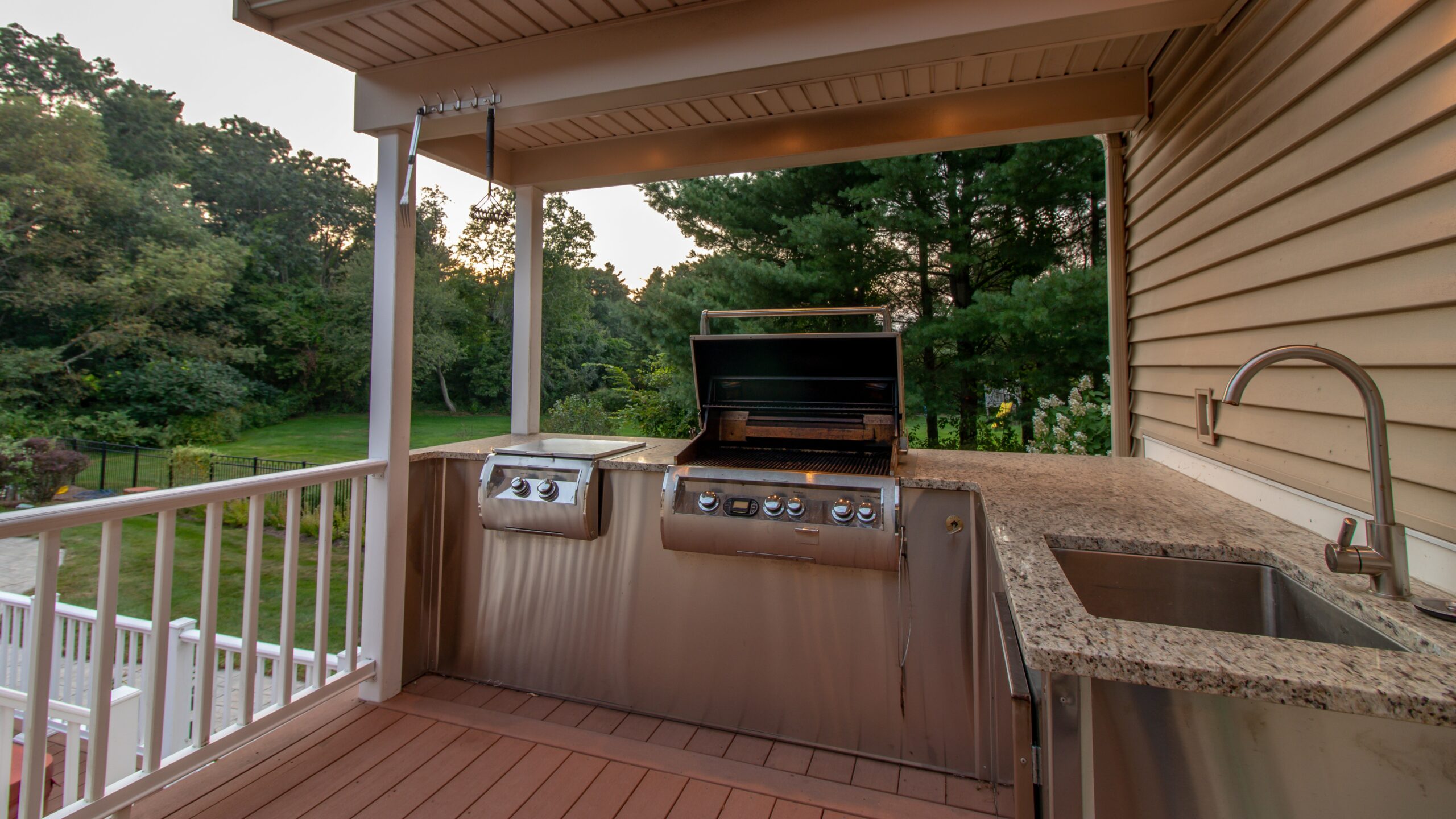 outdoor kitchen with grill, sink and granite countertop
