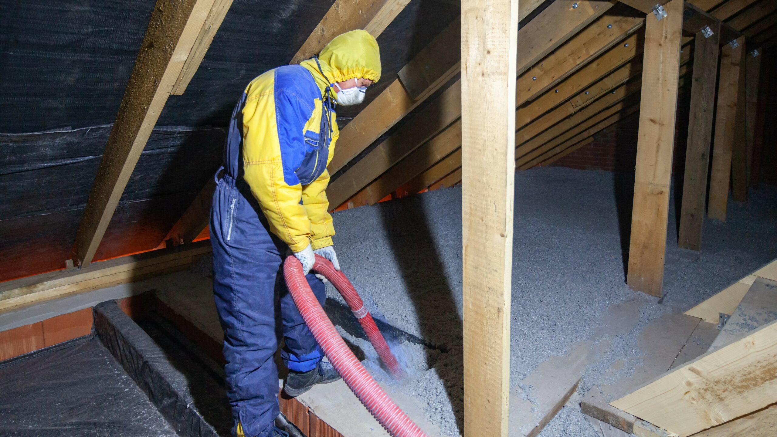 Cellulose insulation being installed in attic.