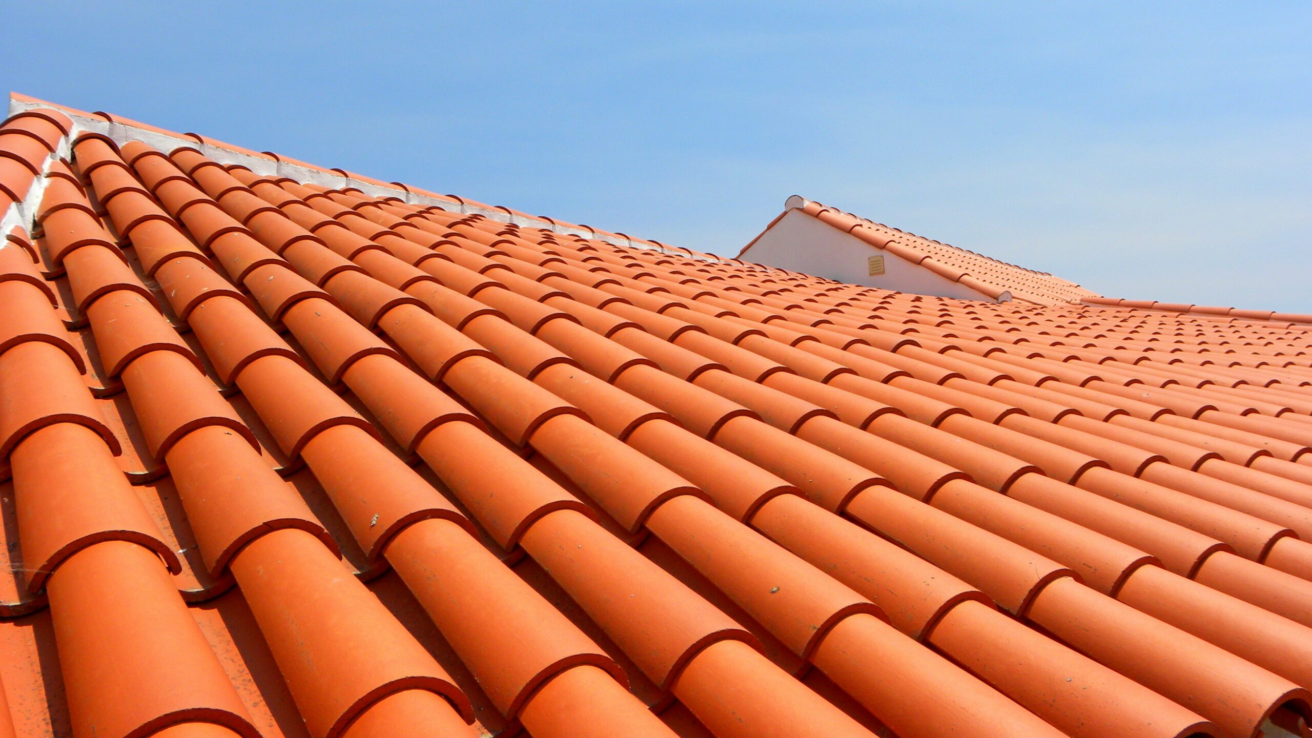 Clay roof tiles under blue sky