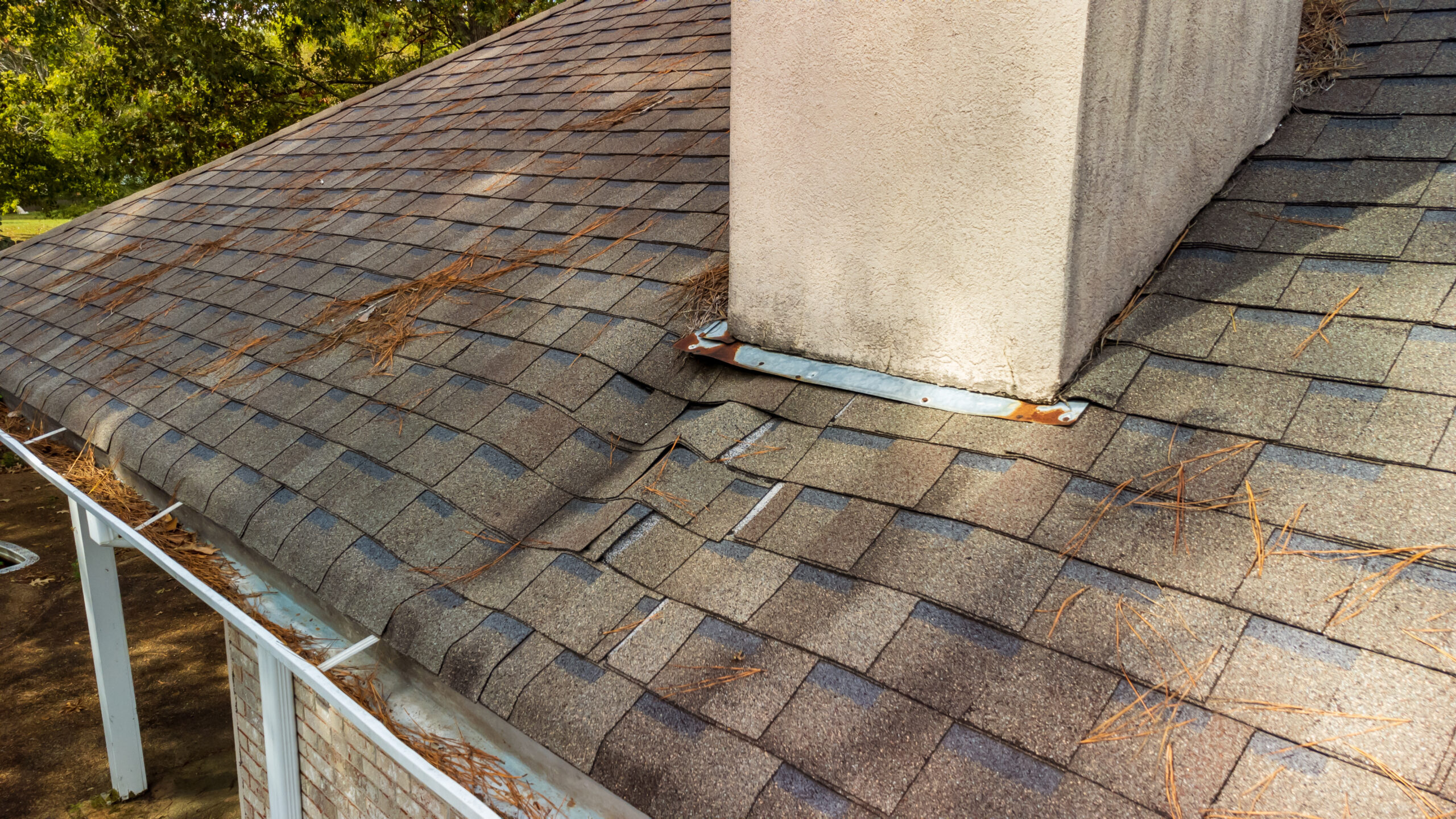 shingles with water damage caused by leak at chimney